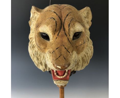 A Victorian candle-illuminated toy, comprising a pair of adorsed mache or composition masks depicting the face of a roaring l