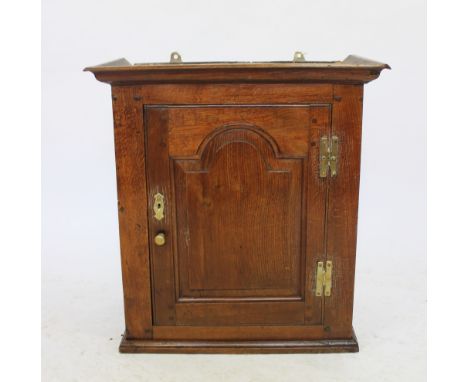 A George III and later oak spice cupboard, with panelled door enclosing a shelf, 64cm H x 59cm W x 30cm D   CONDITION REPORT: