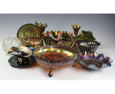 A selection of black and purple iridescent carnival glass ware including, a leaf and grape vine decorated tripod centre bowl,