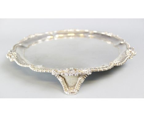 A Victorian silver salver, Hunt & Roskell, London 1900, of canted circular form with cast shell moulded and gadrooned rim, ce