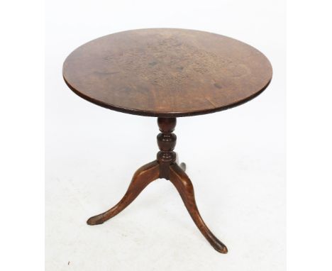 A George III oak occasional table, the single piece circular top with later carved detailing, on a turned column and tripod b