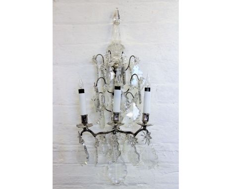 A pair of 19th century style French glass wall lights, three branch with faceted pinnacle tops and cut class lustre drops, 68