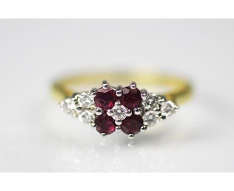 A ruby and diamond ring, designed as four central rubies, with central diamond and flanked by three diamonds to either side, 