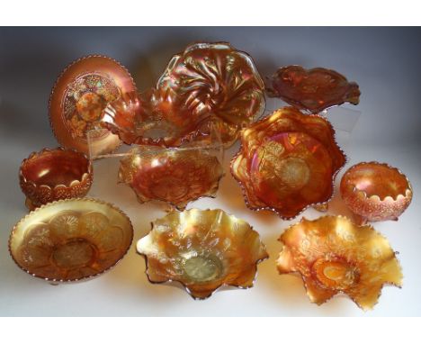 A large selection of marigold carnival glass tripod bowls and shallow dishes, largest 26cm diameter (12)