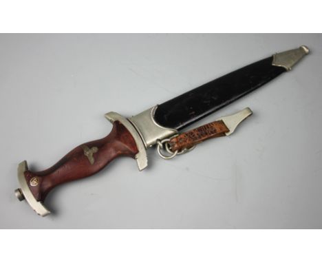 A World War II type German dagger, with 22cm blade stamped 'Gerb Becker Solingen', and leather mounted scabbard 