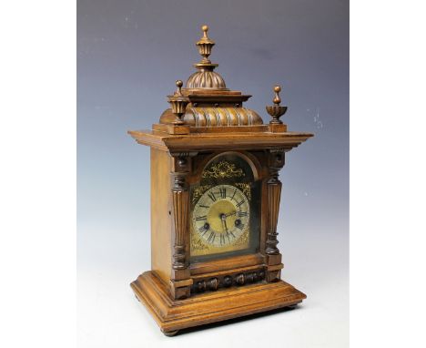 A German walnut and stained beech eight day mantel clock, with silvered Roman numeral chapter ring and movement striking on a