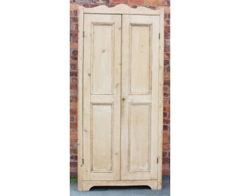 An Edwardian pine hall cabinet, with two panelled doors, (later back panel and hanging shelf), 217cm H x 100cm W x 38cm D