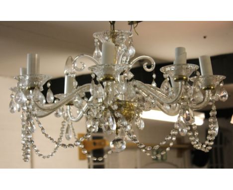 A George III style eight branch chandelier, with flared glass centre  and with glass branches terminating in coupes suspendin
