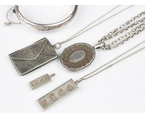 A Victorian silver circular locket with attached chain, two silver ingot pendants and a silver double stamp holder in envelop