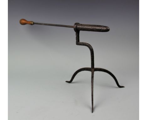 A late 18th century wrought iron goffering iron, on tripod base, with later poker, 28cm high