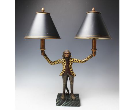 A modern twin light table lamp modelled as a monkey in a fur coat, holding two lights with tole ware type shades, 56cm high C