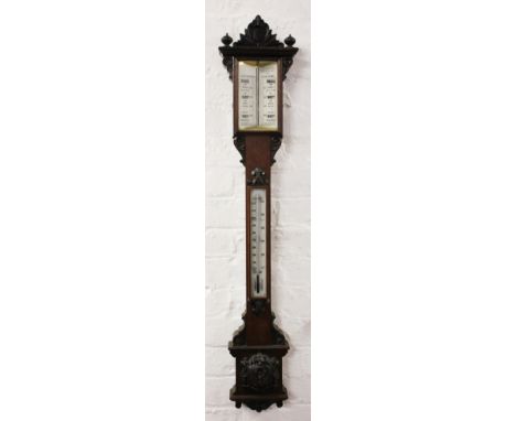 A Victorian carved oak stick barometer, with printed opaque glass scales, 110cm H