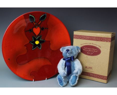 A large Poole studio ware charger, decorated with two lovers in a red glaze, 40.5cm diameter, along with a Steiff Blue 28 Bel