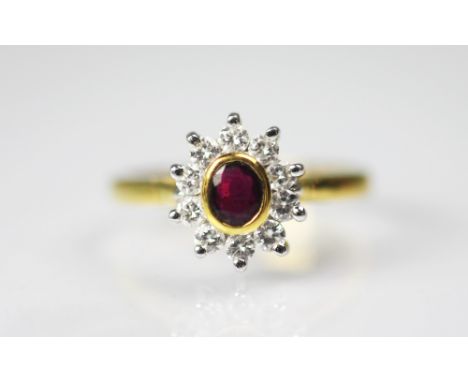 A ruby and diamond cluster ring, the central oval ruby collet set in gold, within a surround of ten brilliant cut diamonds, t