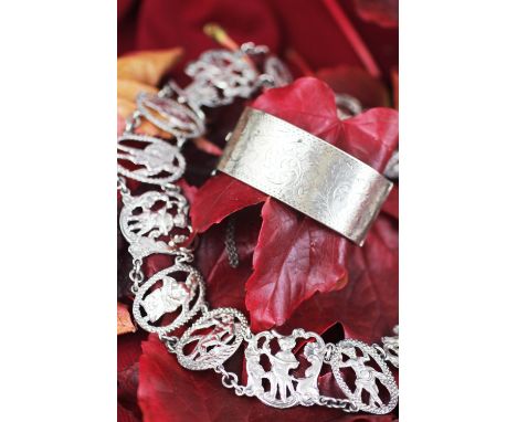 A silver necklace, formed as pierced figural panels, joined by chain links, in the manner of a Victorian belt, 46cm long, gro
