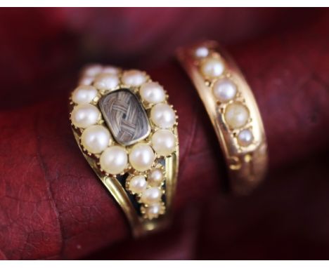 A George IV mourning ring dated 1829, designed as a seed pearl cluster enclosing a locket aperture containing plaited hair, w