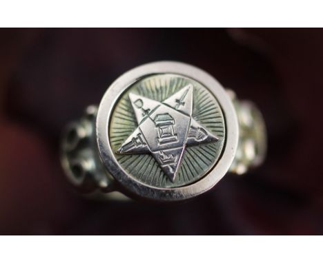An unusual Masonic ring, the central panel with circular swivel panel, one side blank, the other side with star and various e