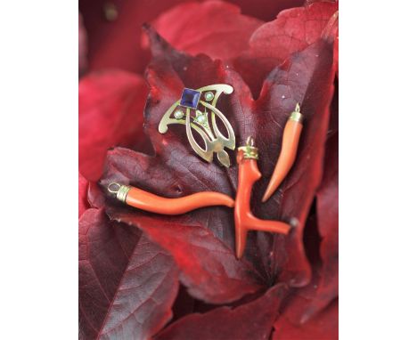 An Art Nouveau amethyst set sinuous pendant and three stick coral pendants (4) 