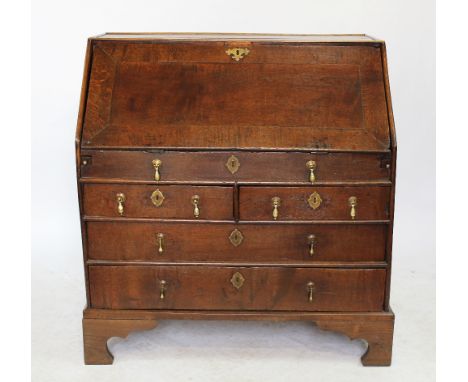 A George III and later oak bureau, with fall over two short and two long drawers, on bracket feet, 97cm H x 91cm W x 57cm D  