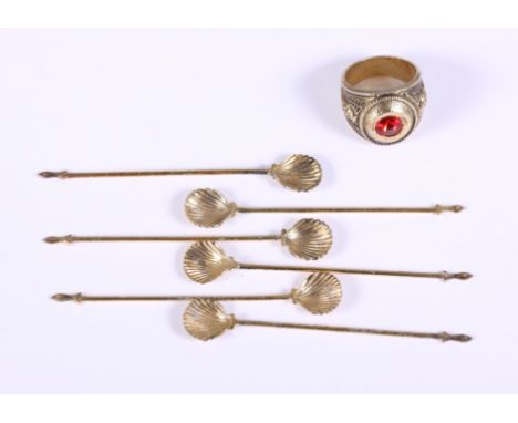 A gentleman's gilt ring, set with a red stone, together with a set of six gilt condiment spoons with shell bowls, 8cm long