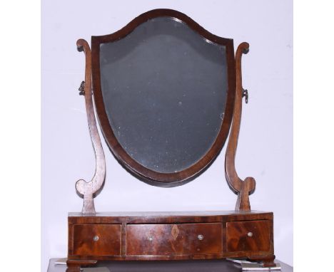 A late Georgian mahogany shield-shaped toilet mirror, on bowfront plateau base, fitted three drawers, on bracket feet, 17" wi
