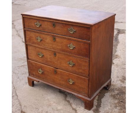 An early 19th century oak chest of four graduated long drawers, on bracket feet, 34" wide