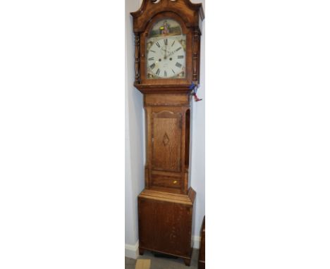 A 19th century figured oak and mahogany banded long case clock with swan neck pediment, painted arch top dial with milkmaid a