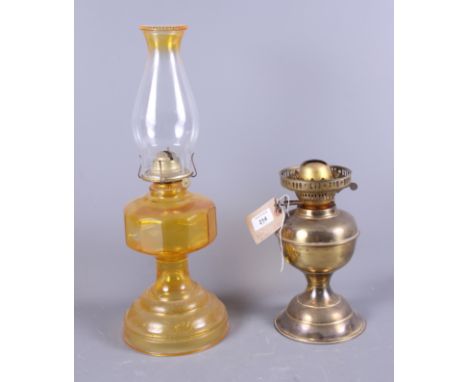 An early 20th century pressed glass oil lamp together with one other oil lamp