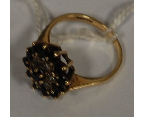 A ladies 9ct gold sapphire and diamond point cluster ring