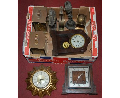 A box of mantel clocks to include; 1930s oak example, composition starburst Smiths eight day wall clock, metal figural table 