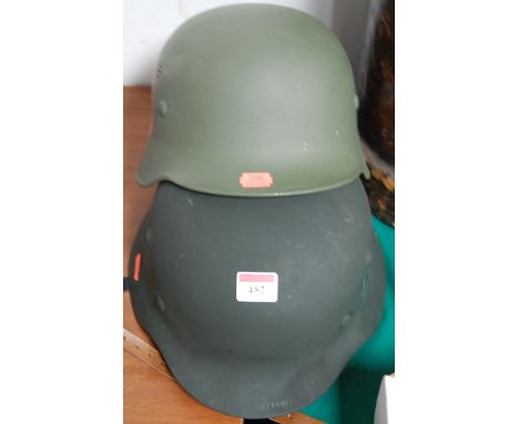 A reproduction WWII period German SS helmet and one other (2)