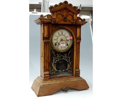An American walnut and beechwood  cased mantel clock