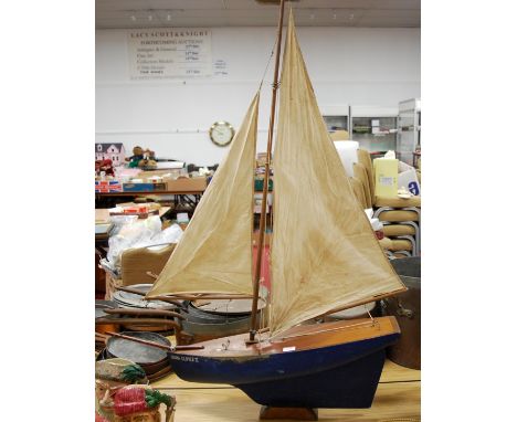 A scale model of a single masted sailing boat named China Clipper II, with blue painted hull