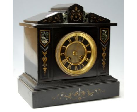 A circa 1900 slate mantel clock having a striking brass cylinder movement