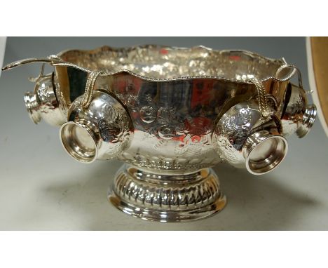 A silver plated pedestal punch bowl with four cups and serving ladle