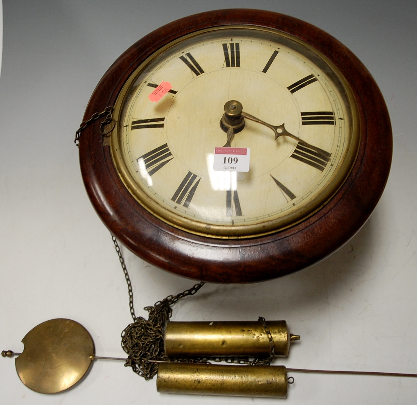 A late Victorian postman's alarm type wall clock striking on a bell