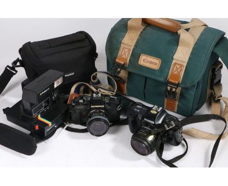Collection of cameras to include Polaroid Supercolor 635CL, Olympus OM40 and an Olympus OM101 Powerfocus with carrying bags (