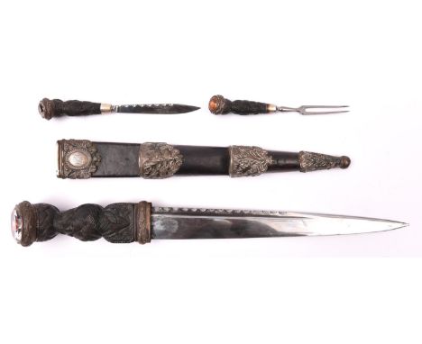 A good Victorian silver mounted Scottish dirk, blade 11½" with scalloped back edge, the ebony hilt of classic form carved wit