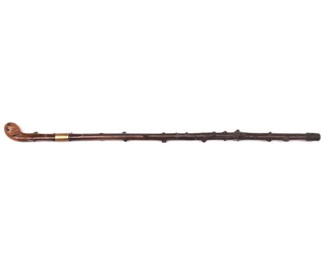 A swordstick, blade 27", with locking catch, knobbly haft, knobbly rootwood handle, and brass band. GC £50-80