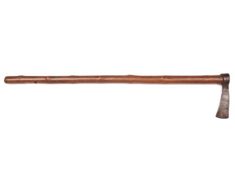 An old Omani Jerz axe, the narrow hatchet blade 5", with punched incised and hatched decoration, on its 30" knotty wooden haf