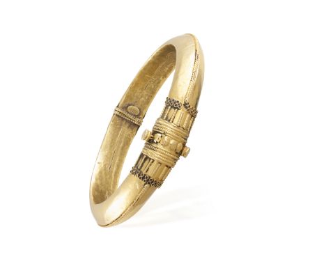 A GOLD BANGLE BRACELET, of Etruscan revival style with corded wire-work and granulation detail throughout, 'stamped 22K', inn