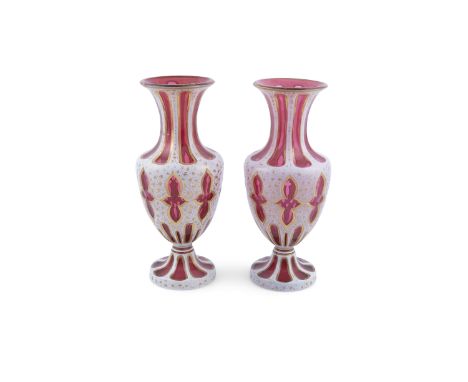 A PAIR OF RUBY FLASHED GLASS VASES, BOHEMIAN, 19th century of baluster shape, overlaid with white and gilt decoration on a ru