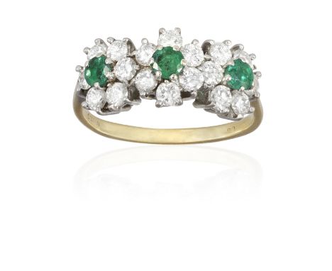 AN EMERALD AND DIAMOND DRESS RING, composed of three circular-cut emeralds, each within a surround of brilliant-cut diamonds,