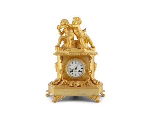 A FINE 19TH CENTURY ORMOLU MANTEL CLOCK, the white enamel dial inscribed Krauel a Troyes, the cresting surmounted by two putt