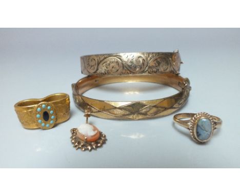 A 9CT GOLD BANGLE WITH METAL CORE, scrolling and foliate decoration, together with a similar example, and a gold & opal ring 