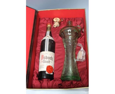 A PRESENTATION CASE OF ASBACH URALT BRANDY, coming with a green crackle glaze decanter and pourer