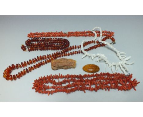 A COLLECTION OF VINTAGE AMBER AND CORAL BEAD NECKLACES, together with a faux amber oval panel, and an unworked amber nugget