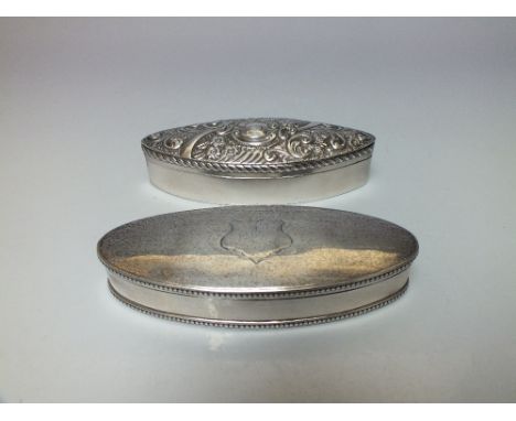 TWO HALLMARKED SILVER OVAL VANITY / BOXES, one of plain form with engine turned decoration and engraved cartouche to the lid,