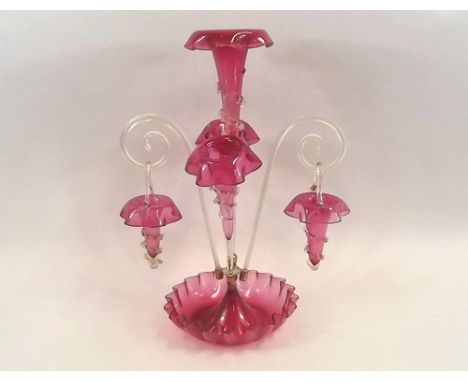 EPERGNE.
A Victorian trailed cranberry glass epergne, with three trumpets, two glass branches & two baskets. Full height 51cm