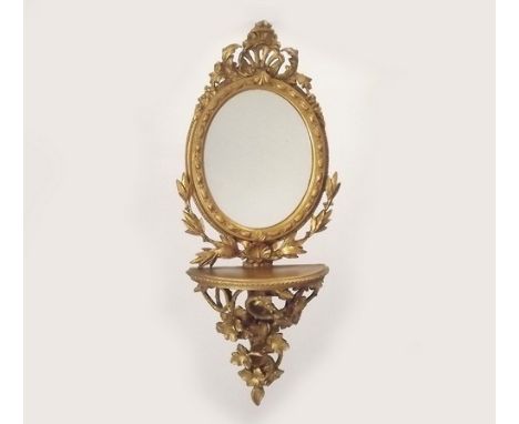 MIRROR.
A gilt wood mirror with shelf bracket.
Height 70cm.